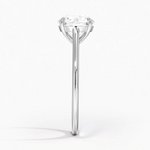 Petite Four Prong Solitaire Round Moissanite Ring